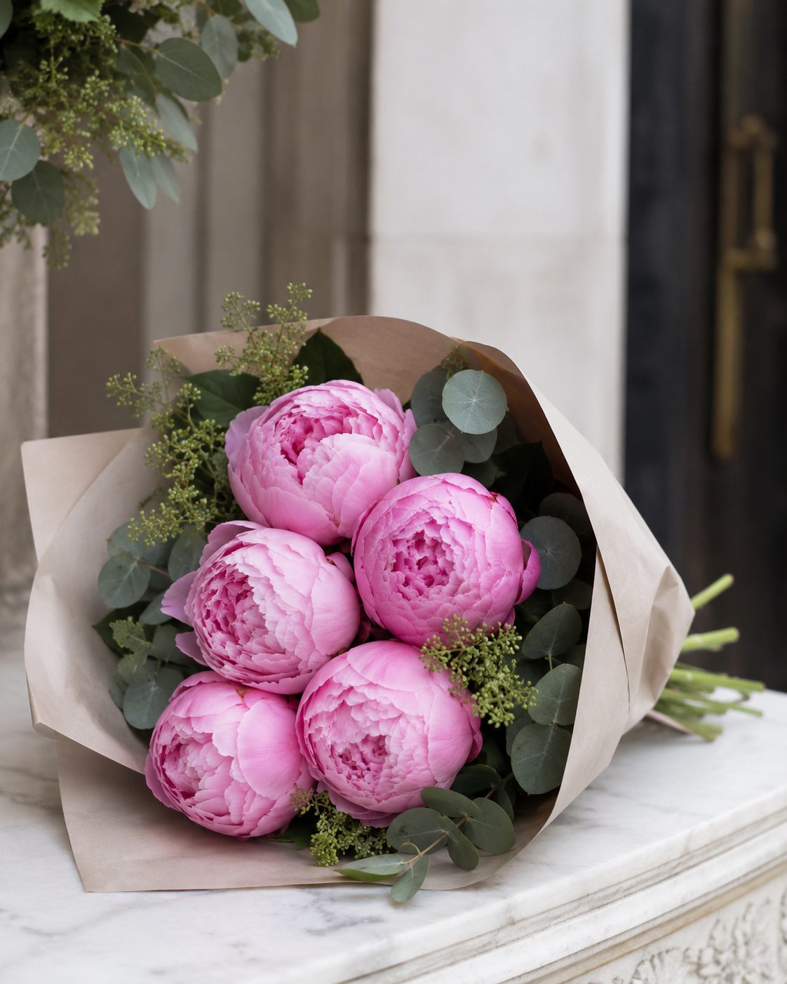 Pink peony bouquet wrapped in natural paper