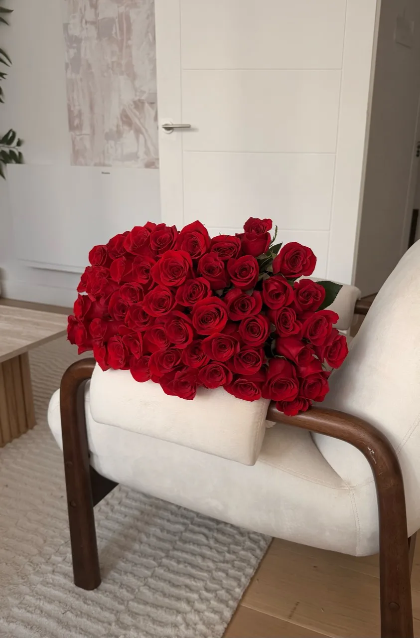 A full bouquet of deep red roses finished with a burgundy ribbon