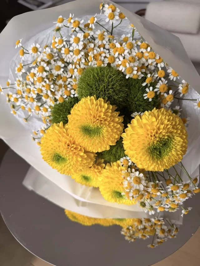 Yellow dahlia bouquet with chamomile and green dianthus