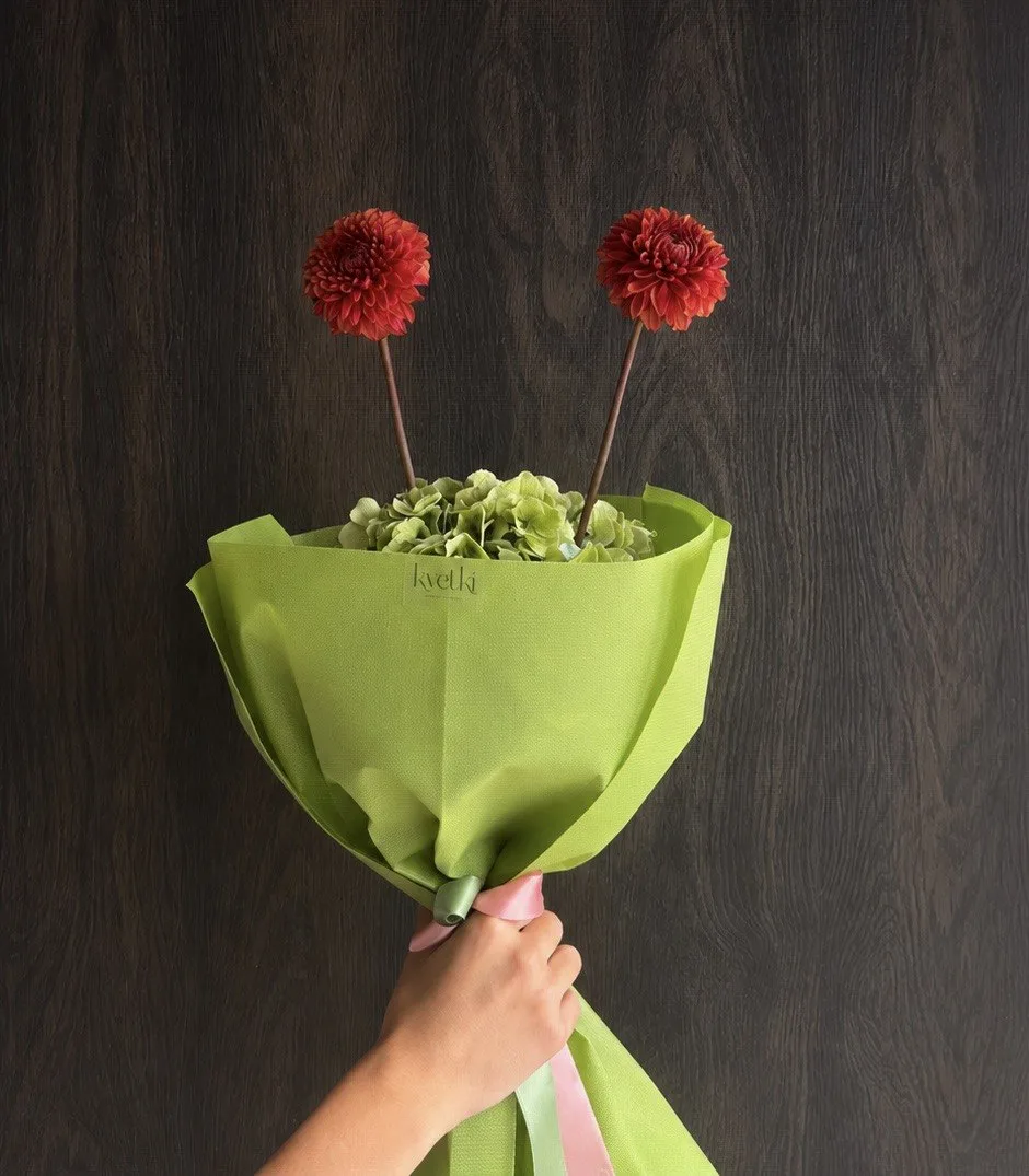 Minimal two-flower bouquet in vivid green wrapping