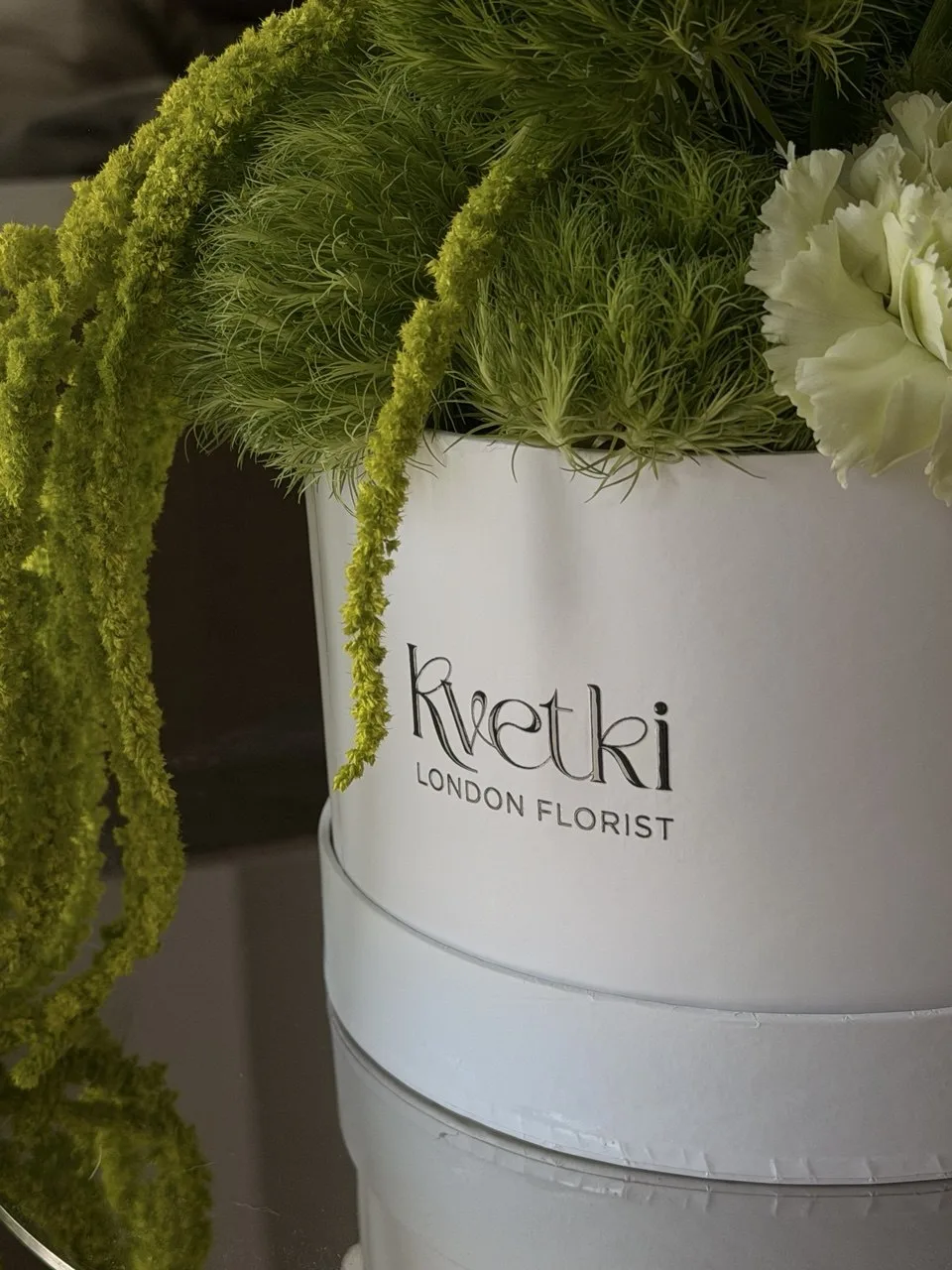 Sculptural green and white flower box with calla lilies
